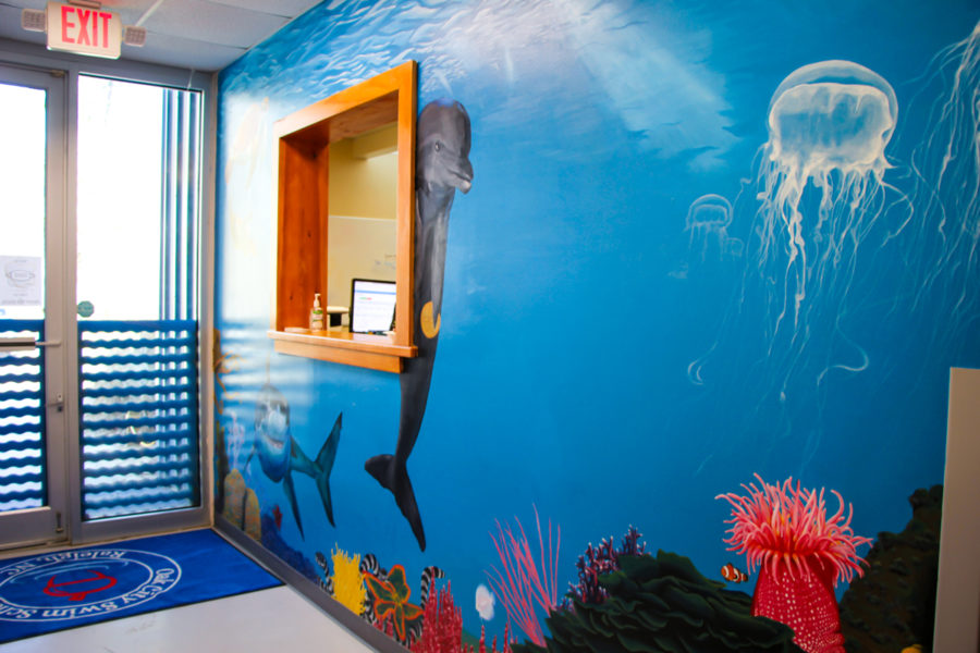 Our swim office window and sea life mural. The side door many people use for swim entrances is in the background.
